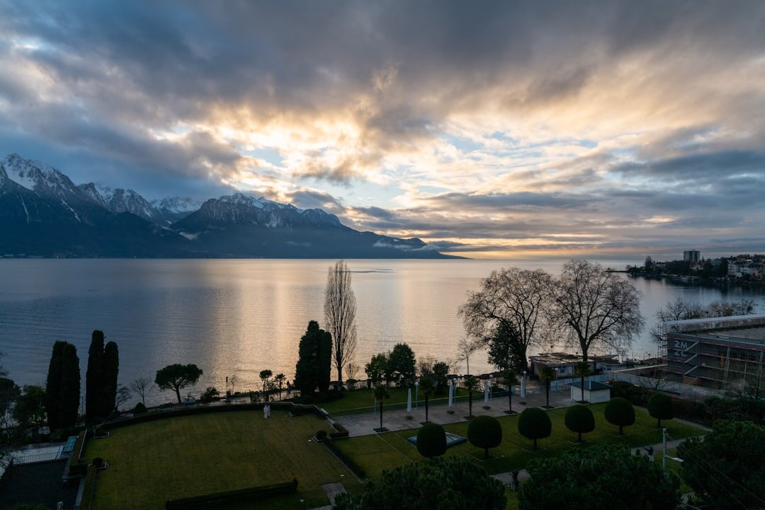 Lake Geneva waterfront with boats and mountains in background